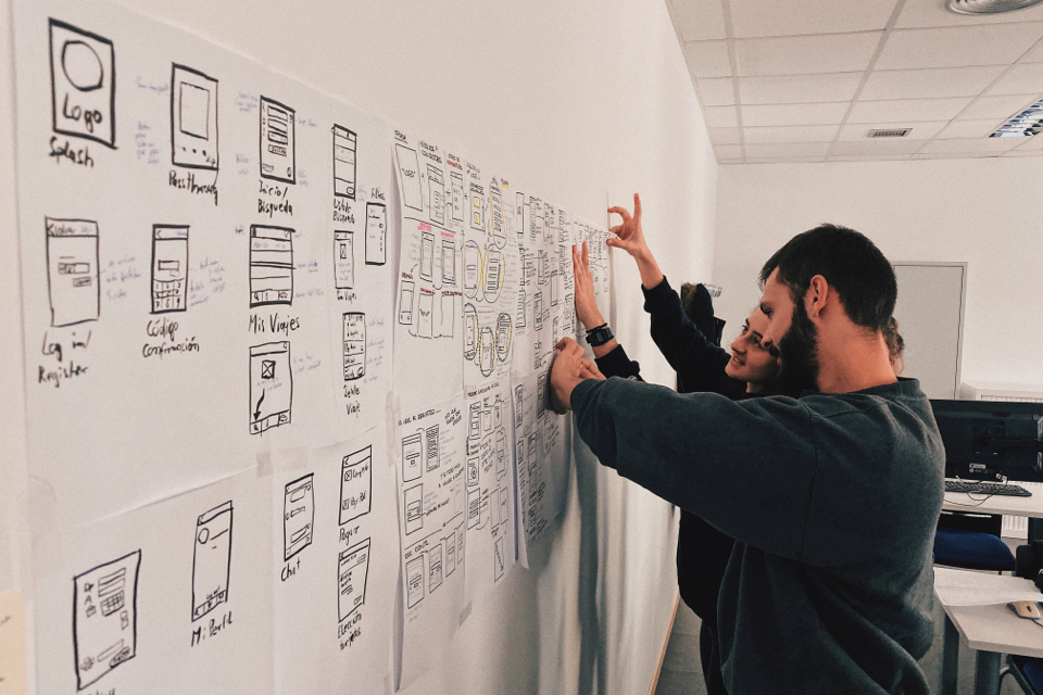 two people working on a whiteboard